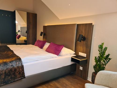 a bedroom with a large bed with red pillows at Residence Black Eagle Lubmin Strand in Lubmin