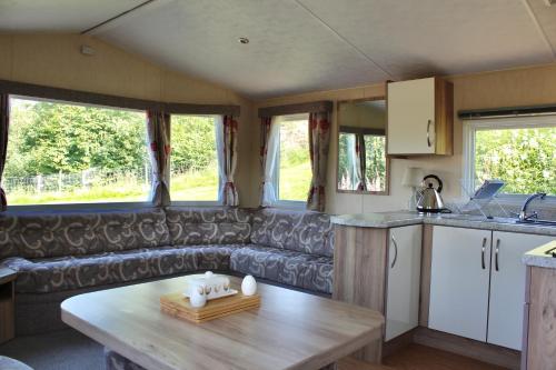 a kitchen and living room of a caravan at Crannich Holiday Caravans in Killichronan