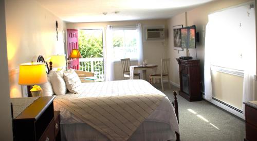 a bedroom with a bed and a balcony at Red Horse Inn in Falmouth