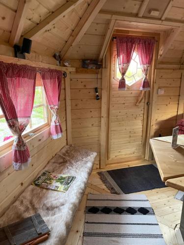 an inside view of a log cabin with two windows at Marina Lauenburg in Lauenburg