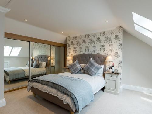 a bedroom with a large bed and a window at Rye Cottage in Helmsley