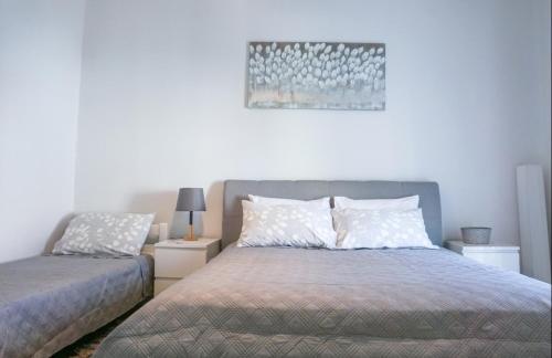 a bedroom with a bed and a picture on the wall at Emma & Toni in Biograd na Moru