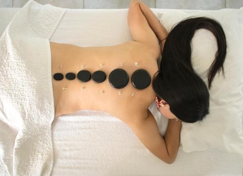 a woman laying on a bed with a shirtless at Hotel Hacienda Santa Clara in Santa Rosa de Cabal