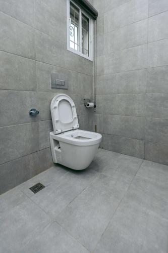 a bathroom with a toilet with the seat up at Phoenix Luxury Apartments in Abuja