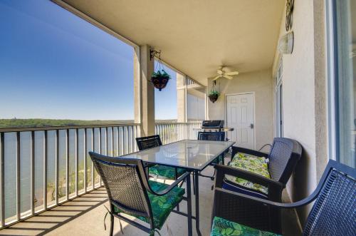 a balcony with a glass table and chairs at Lakefront Osage Beach Condo Balcony and Pool Access in Osage Beach