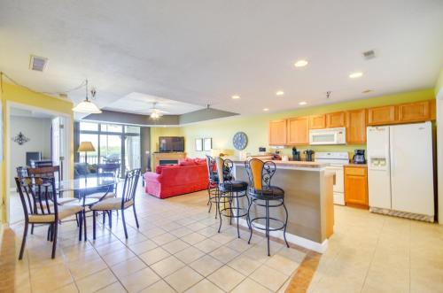 a kitchen and living room with a table and chairs at Lakefront Osage Beach Condo Balcony and Pool Access in Osage Beach