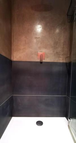 a bathroom with a red soap dispenser on the wall at Gwynn Lodge in Newquay