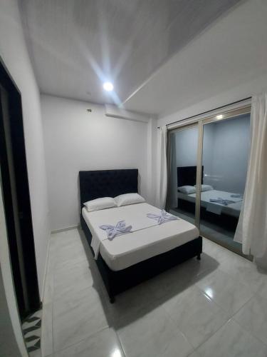 Ένα ή περισσότερα κρεβάτια σε δωμάτιο στο HOTEL HAUSE San Antero Córdoba
