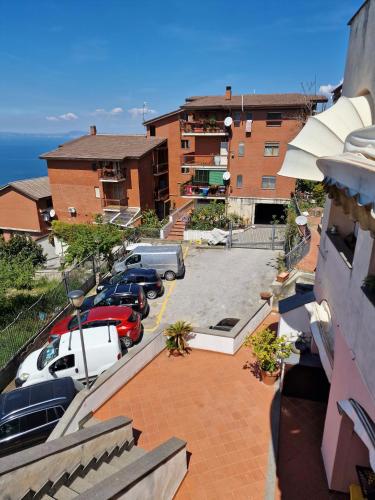 a parking lot with cars parked in front of a building at Maison Danielle in Vico Equense