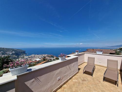 a balcony with two chairs and a view of the ocean at Maison Danielle in Vico Equense