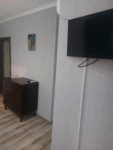 a living room with a flat screen tv on a wall at Sweet home in Tbilisi City