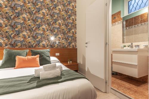 a bedroom with a large bed with a wallpaper at Vittoria Garden Suites in Rome