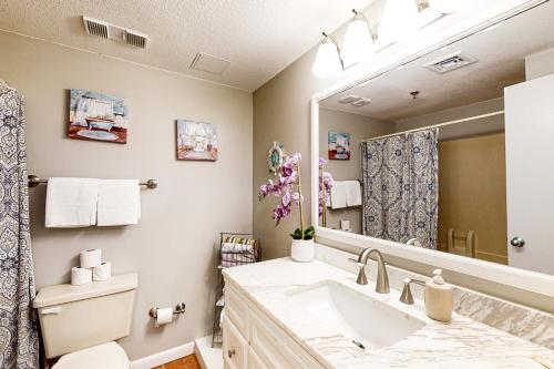 a bathroom with a sink and a mirror at Pirates Bay A104 in Fort Walton Beach