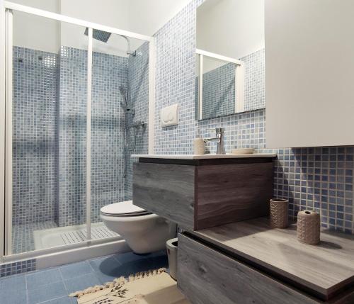 a bathroom with a toilet and a sink and a shower at Goccia Smeraldo - Gocce sul Mare in Savelletri di Fasano