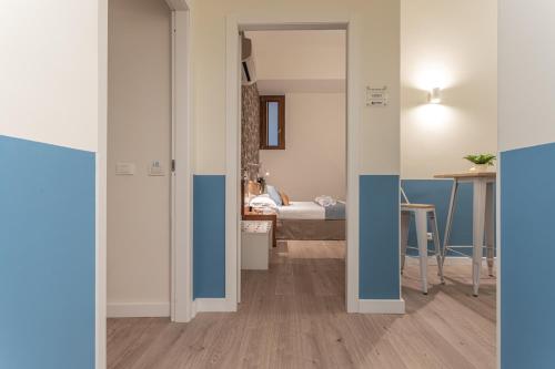 a room with a hallway with a bed and a table at Vittoria Garden Suites in Rome
