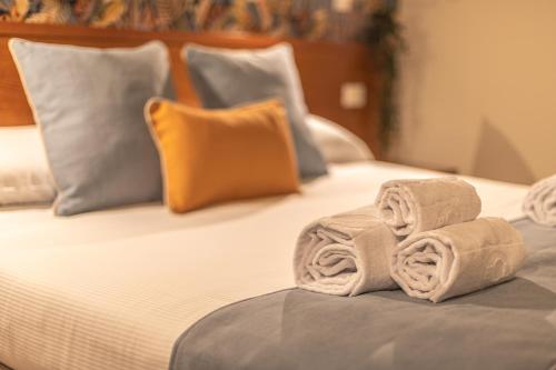 a couple of towels sitting on top of a bed at Vittoria Garden Suites in Rome
