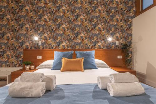 a bedroom with a large bed with two pillows at Vittoria Garden Suites in Rome