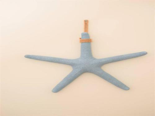 a blue starfish hanging on a white wall at Sunset Cove # 303 in West Bay