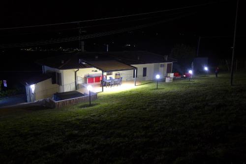 a house with lights in the yard at night at Casavacanzedezza in Montecalvo Versiggia