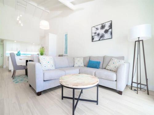 a living room with a couch and a table at Sunset Cove # 303 in West Bay