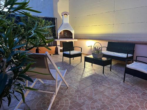a room with couches and chairs and a fireplace at Terre Saracene Suites in Bitonto