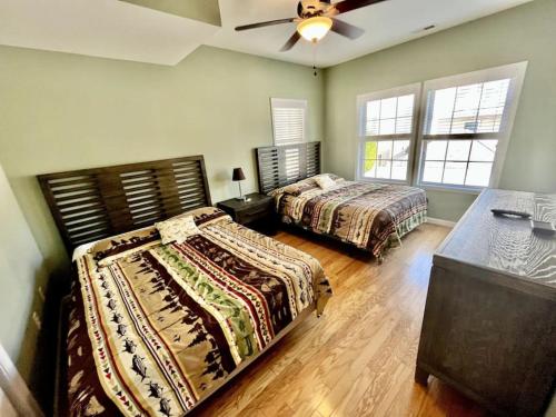 a bedroom with two beds and a ceiling fan at Beach Block 4 Bedroom with POOL in North Wildwood