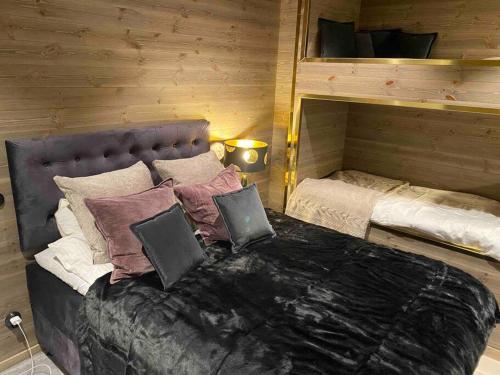 a bedroom with a bed and a bunk bed with pillows at Vackert fjällhus med underbar utsikt in Järvsö
