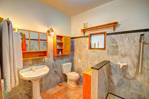 a bathroom with a sink and a toilet and a shower at Rolling Stolis Home in Katávolos