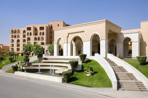 a building with stairs and a fountain in front of it at InterContinental Durrat Al Riyadh Resort & Spa by IHG in Riyadh