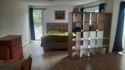 a bedroom with a bed and a book shelf at Apartement auf dem Lande in Rudelzhausen