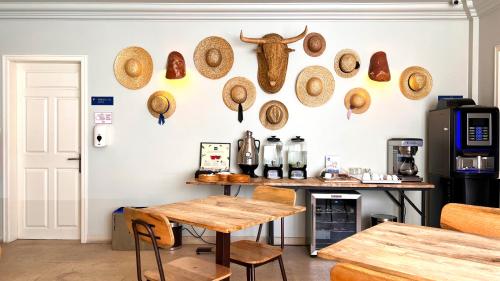 a room with a table and some hats on the wall at Jardim da Lapa by Shiadu in Lisbon