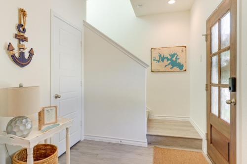 a hallway with white walls and a staircase with a white door at Canyon Lake Home Rental Boating, Patio and More! in Canyon Lake