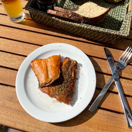 a plate of food with a piece of bread on a table at Ferienwohnungen Kapitänskajüte & Ausguck in Maasholm