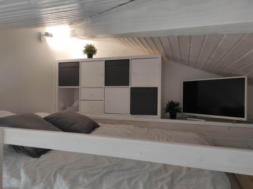 a bedroom with a bed and a tv on a wall at Chalet 60m² entièrement climatisé in Gassin