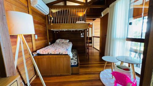 a small bedroom with a bed in a small room at Ilha do Mel Lodges in Ilha do Mel
