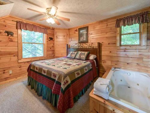 a bedroom with a bed and a bath tub at Cub’s Cove, 1 Bedroom, Near Downtown, View, Jetted Tub, WiFi, Sleeps 4 in Gatlinburg