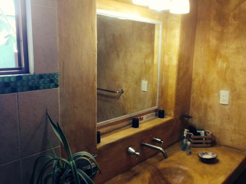 a bathroom with a sink and a large mirror at Maria Del Alma House in Mexico City