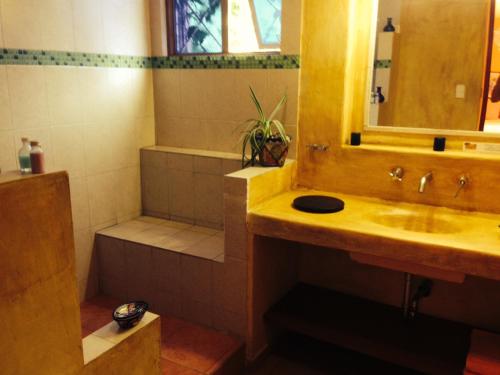 a bathroom with a sink and a shower and a tub at Maria Del Alma House in Mexico City