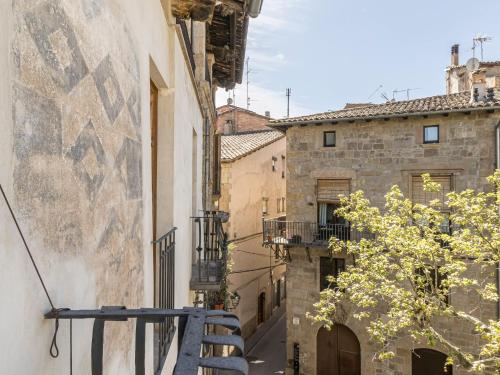 an alley in an old town with a blue bench at Cal Rellotger de Solsona in Solsona