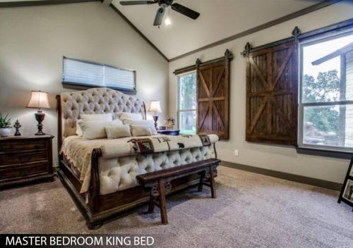 a bedroom with a large bed and a large window at Hilltop Ranch House - Holiday & Family Destination in Valley View