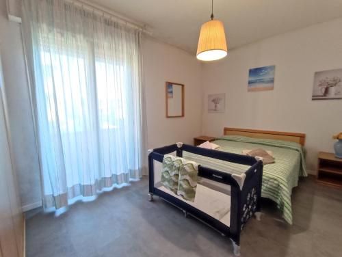 a bedroom with a bed and a large window at L'Orchidea_Holiday in Camaiore
