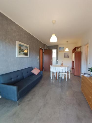 a living room with a blue couch and a table at L'Orchidea_Holiday in Camaiore