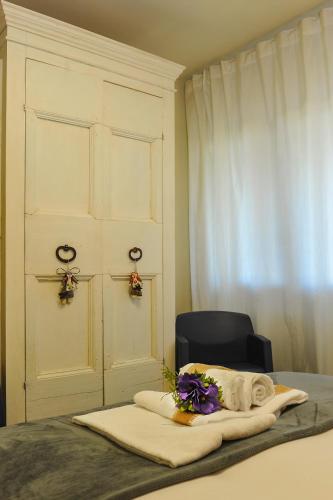 a bedroom with a bed with a chair and a window at Lake View 30 in Sulzano
