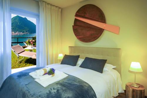 a bedroom with a large bed with a large window at Lake View 30 in Sulzano