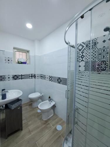 a bathroom with a toilet and a sink and a shower at Domus de loco sano in Castellammare di Stabia