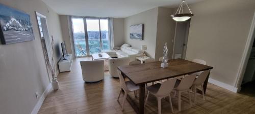 a dining room and living room with a table and chairs at NEW LUXURY APARTMENT 2Br 2Ba DIRECT BEACH ACCESS in Hollywood Beach