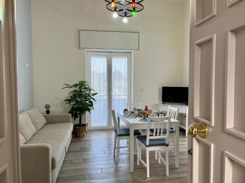 a living room with a white table and a couch at Il Ponte a Vapore Guest House in SantʼAnastasia