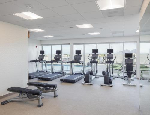 a gym with rows of treadmills and elliptical machines at SpringHill Suites by Marriott Tucson at The Bridges in Tucson