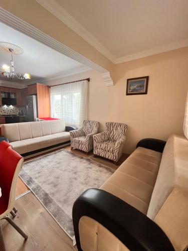 a living room with a couch and chairs at VİLLA DALAMAN in Dalaman