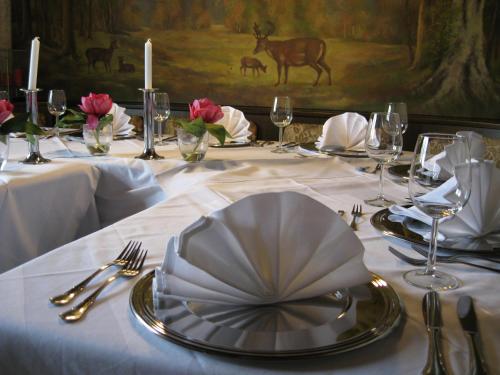 a table with a white table cloth with a plate on it at Kurhotel Würdinger Hof in Bad Füssing